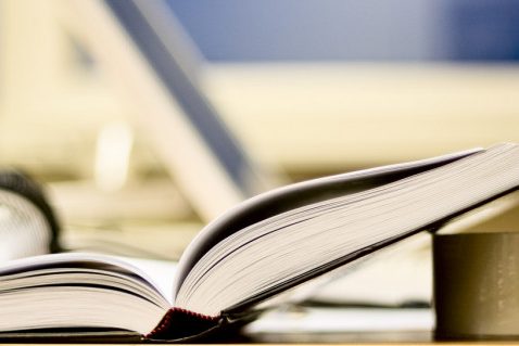 depositphotos_5684391-stock-photo-open-book-on-office-table