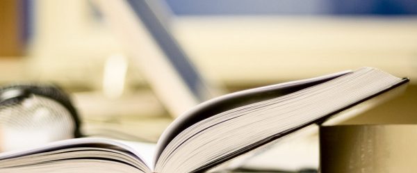 depositphotos_5684391-stock-photo-open-book-on-office-table