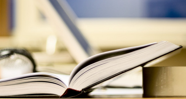 depositphotos_5684391-stock-photo-open-book-on-office-table